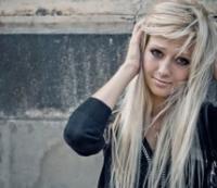 Blonde girl portrait against concrete wall backdrop
