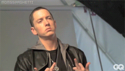 Eminem mid-interview, hands up in gesture