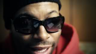 Guy in shades and beanie talking to camera
