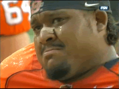 Emotional football player, tearful sideline moment captured