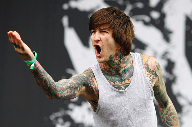 Tattooed vocalist mid-scream on stage, tribute memory