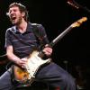 Guitarist rocking out on stage mid-performance