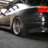 Stanced dark coupe with polished aftermarket wheels