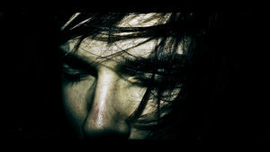 Moody dark portrait with windswept hair, staff intro pic