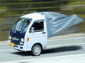 Tiny truck loses its cover cape on the highway