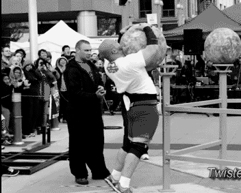 Strongman heaves giant ball at street competition