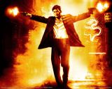 Silhouetted figure with guns raised against fiery backdrop